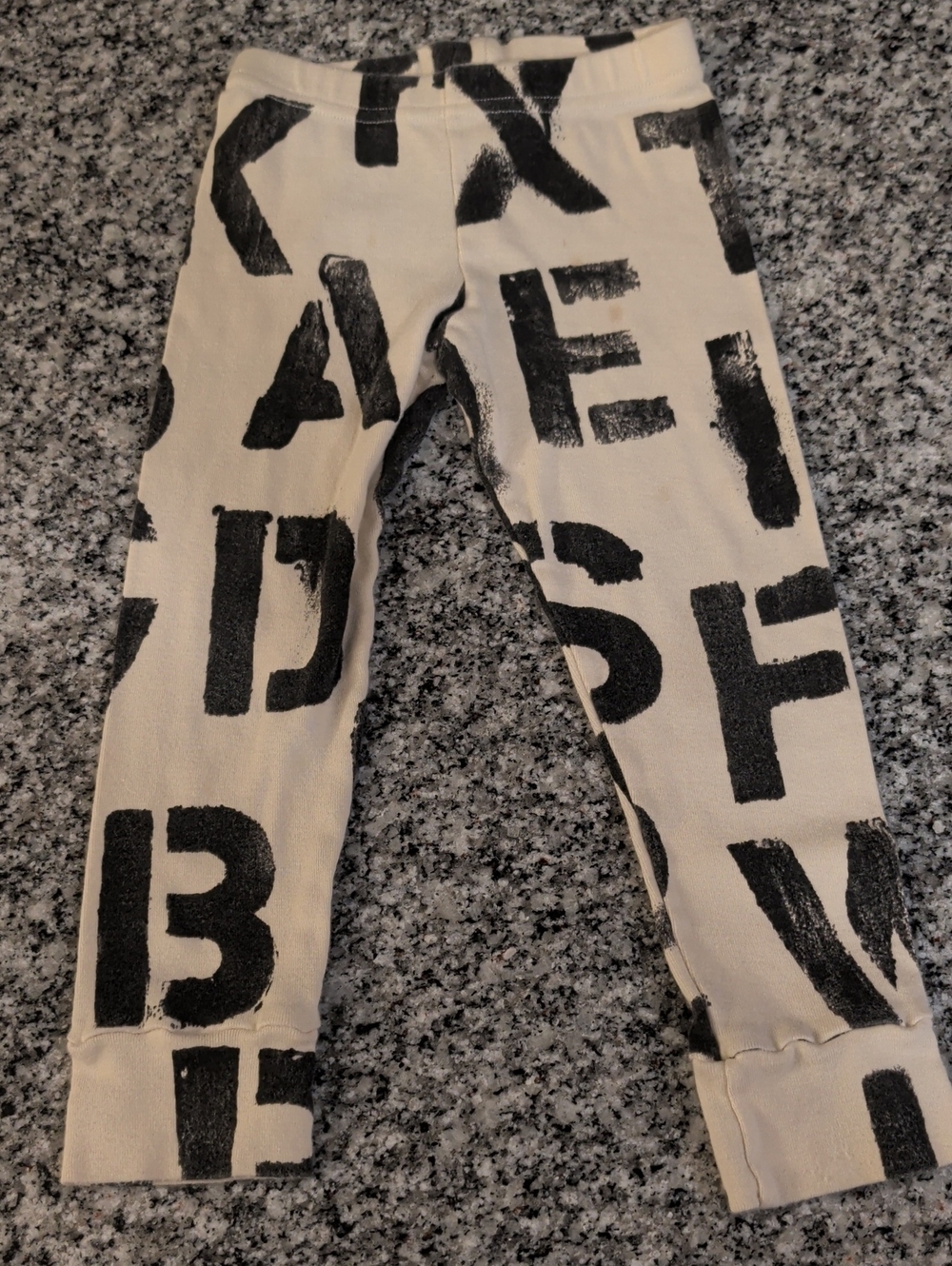 nununu Cream Leggings with Black Letter Graphic